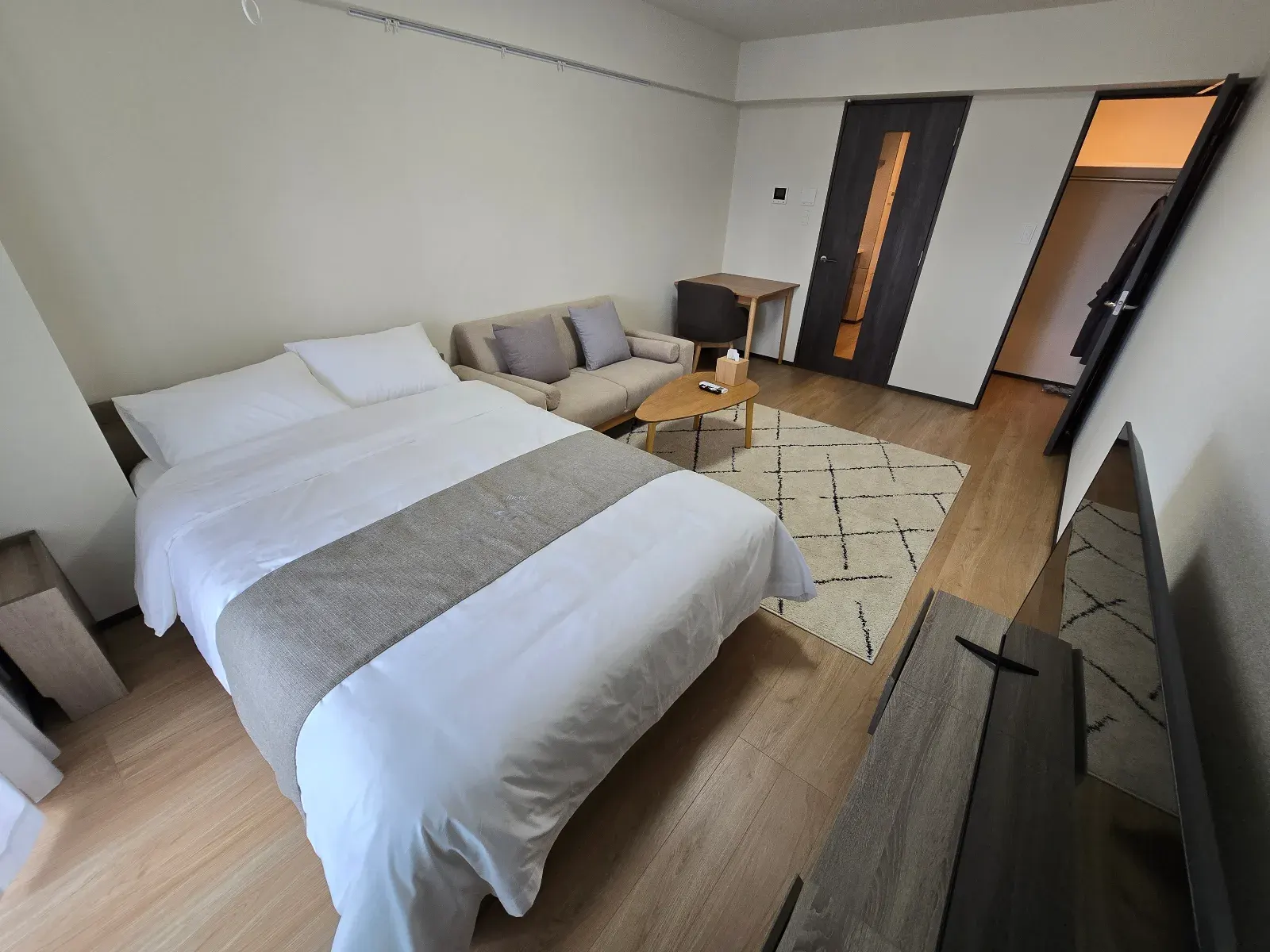 A furnished HIVEN Tokyo residence prepared for a 29 night long stay with desk, suitcase, kitchen items, and local support notes.
