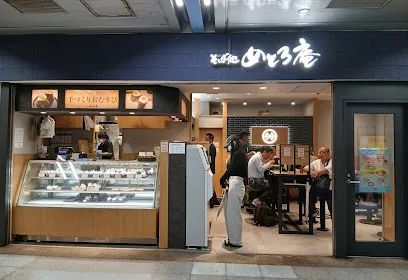 Customers eating soba quickly at a narrow standing counter in Tokyo.