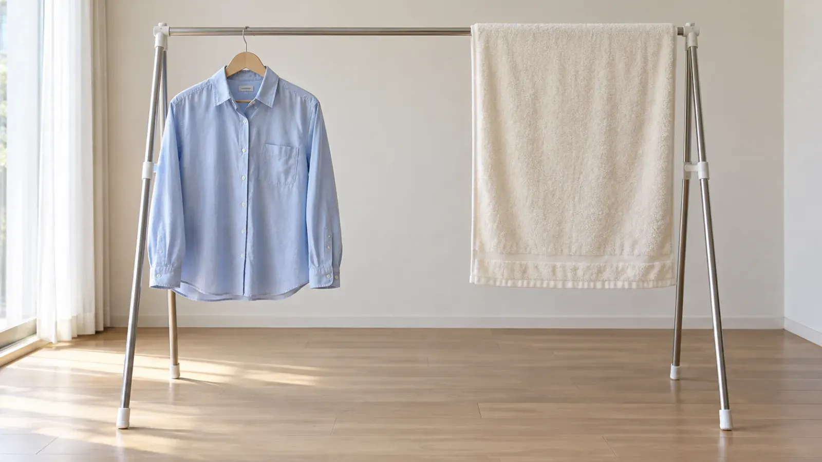 A towel and shirt hanging separately with open space around them.