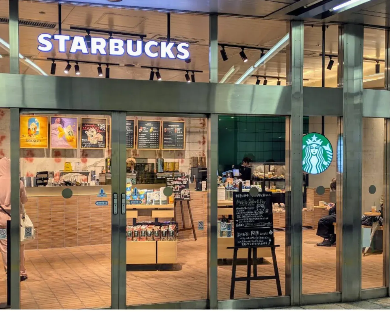 A coffee and small sweet near Kinshicho Station at night.