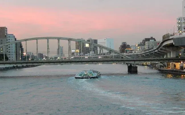 The Sumida River opening into view from the riverside promenade near Ryogoku.