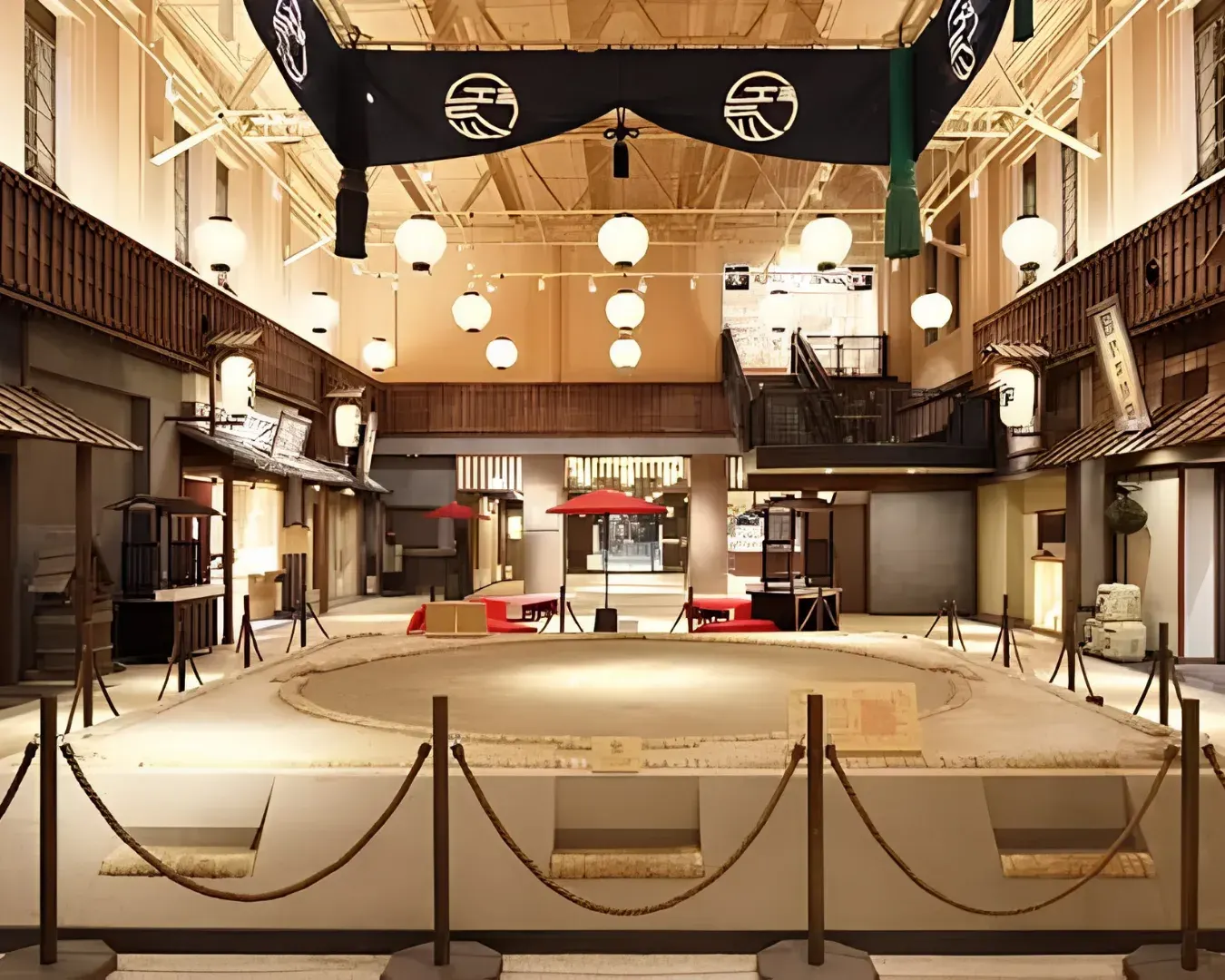 Historic ceremonial sumo aprons displayed with archival photographs at the Sumo Museum in Ryogoku.