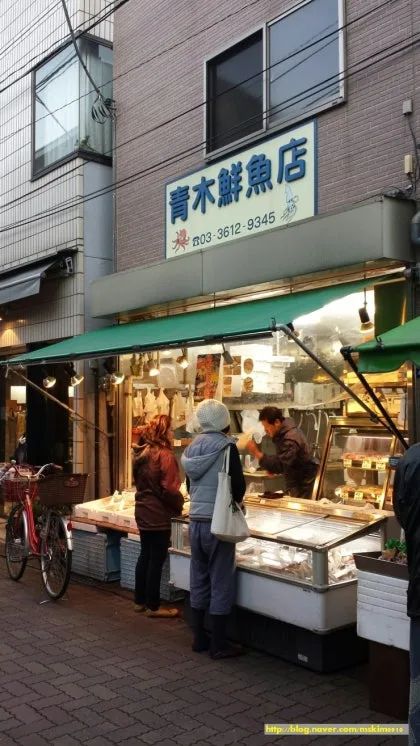Late afternoon on Kira-Kira Tachibana Shopping Street with shutters, bicycles, and people finishing errands.